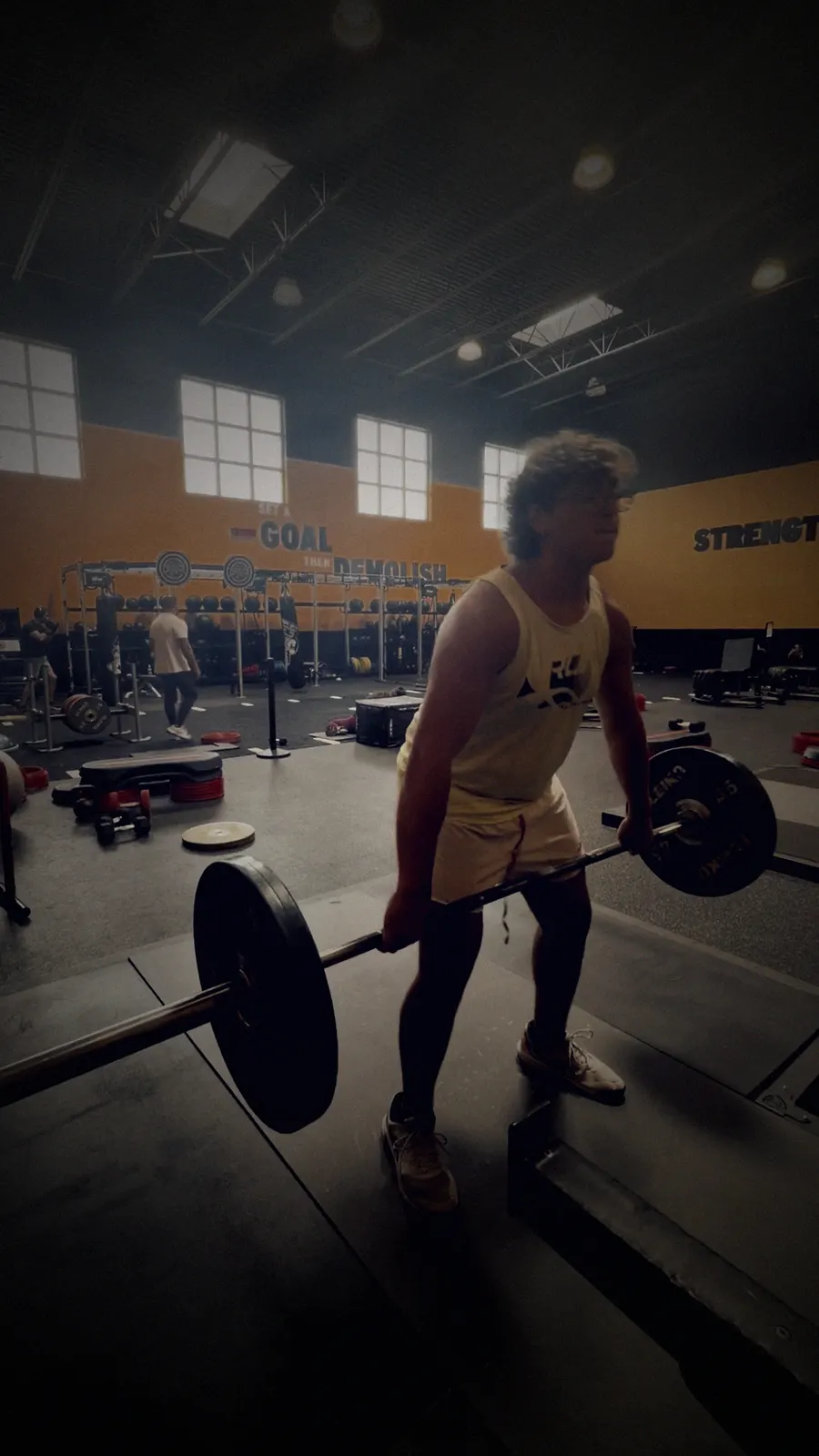 Jaden pulling a loaded barbell in the gym